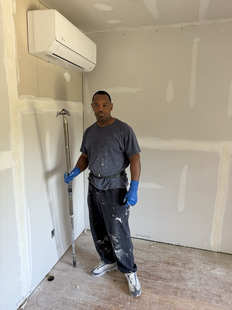 Gary of GEM Finishing in a freshly taped room